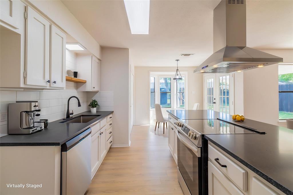 6192 Wrigley Way Fort Worth, TX 76133 - Photo 7 of 22 a kitchen with granite countertop a sink and cabinets