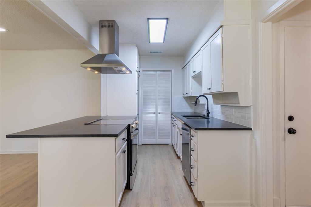 6192 Wrigley Way Fort Worth, TX 76133 - Photo 8 of 22 a kitchen with stainless steel appliances granite countertop a sink and a refrigerator