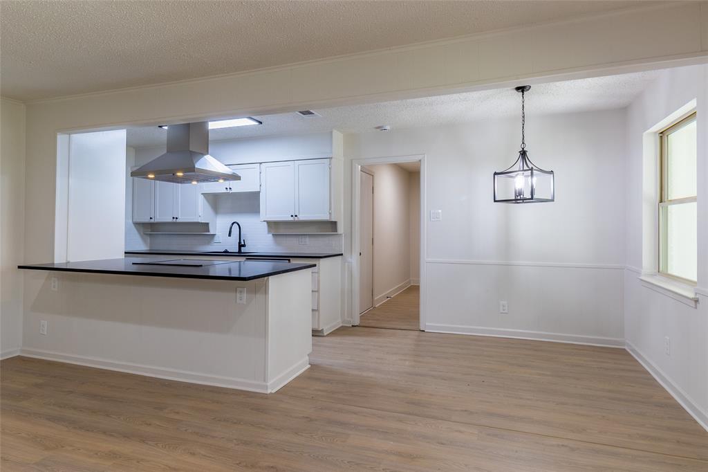 6192 Wrigley Way Fort Worth, TX 76133 - Photo 10 of 22 a kitchen with kitchen island a counter top space and appliances