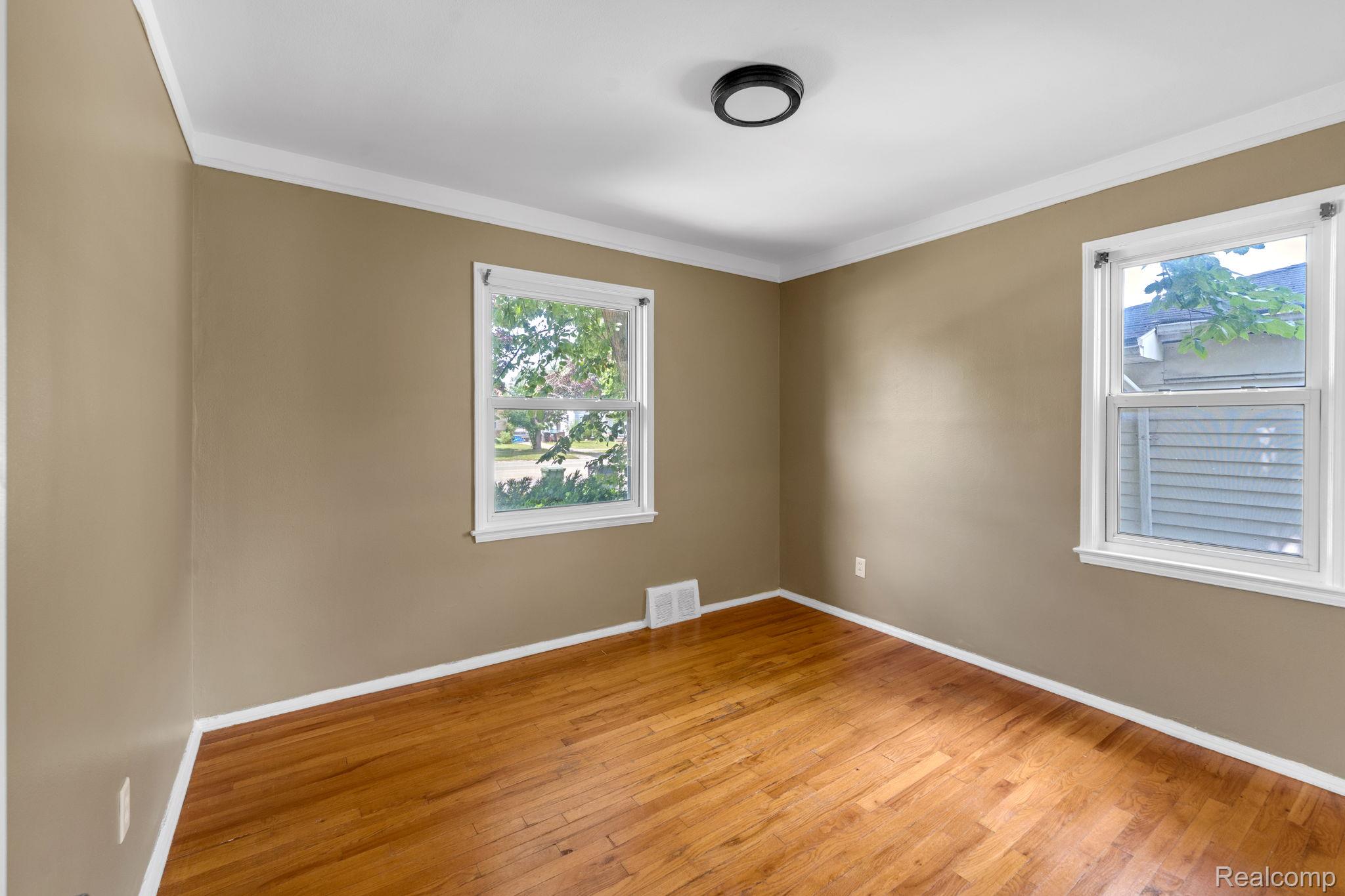 7641 Pelham Road Allen Park, MI 48101 - Photo 11 of 21 Neutral tone walls with white trim and wood-finish flooring