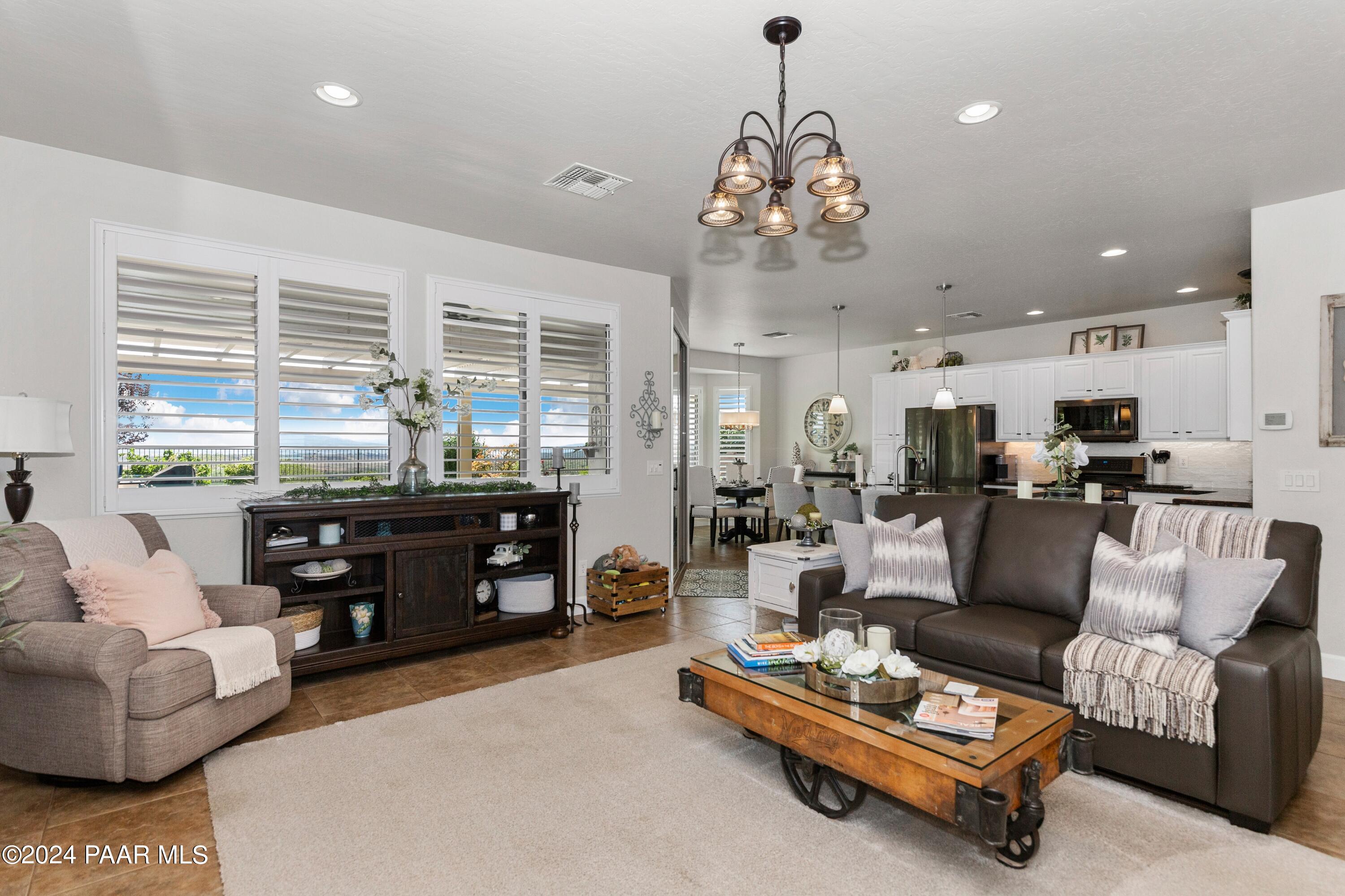 1219 Stack Rock Road Prescott Valley, AZ 86314 - Photo 13 of 41 a living room with furniture fireplace and a chandelier