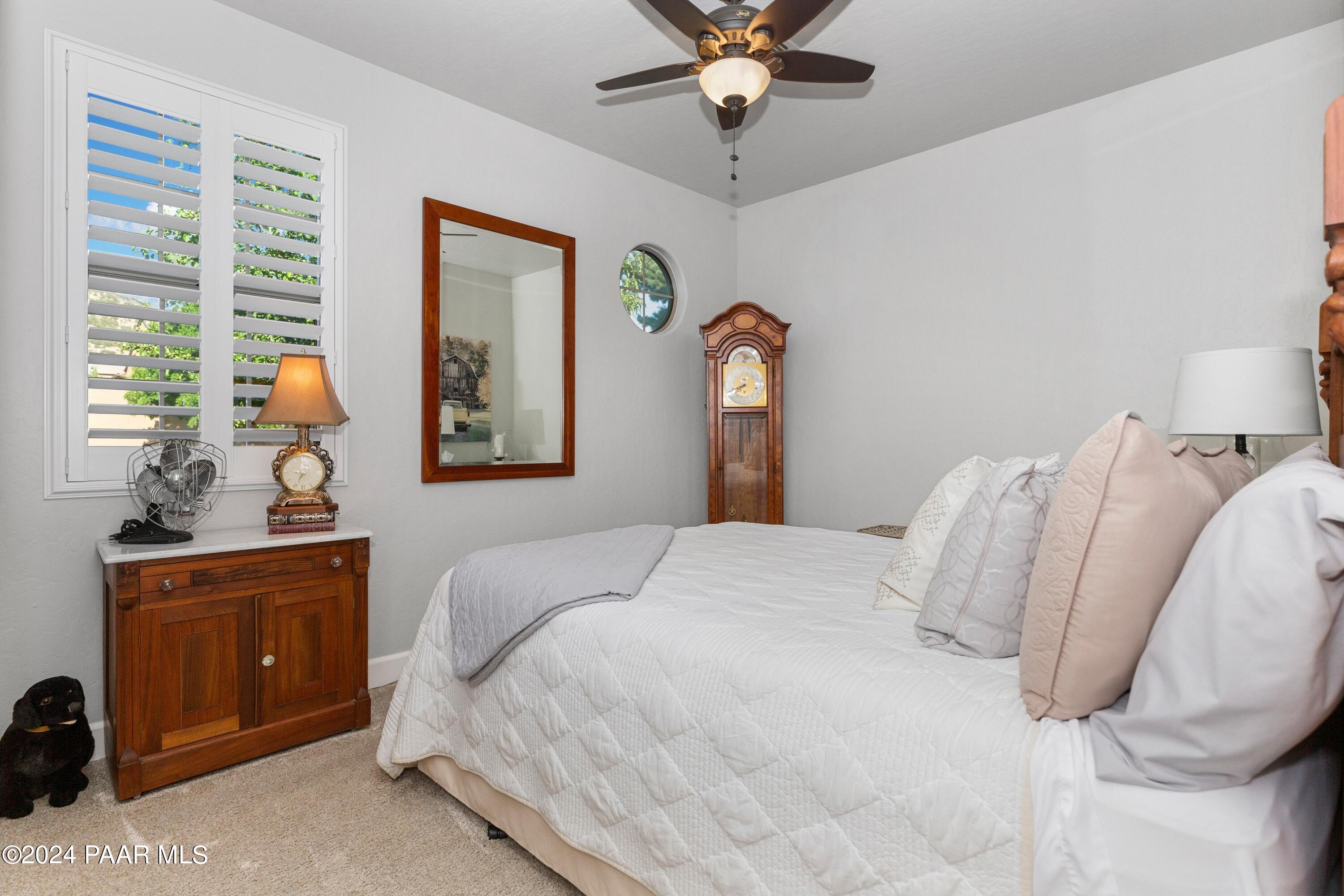 1219 Stack Rock Road Prescott Valley, AZ 86314 - Photo 22 of 41 a bedroom with a large bed and a window