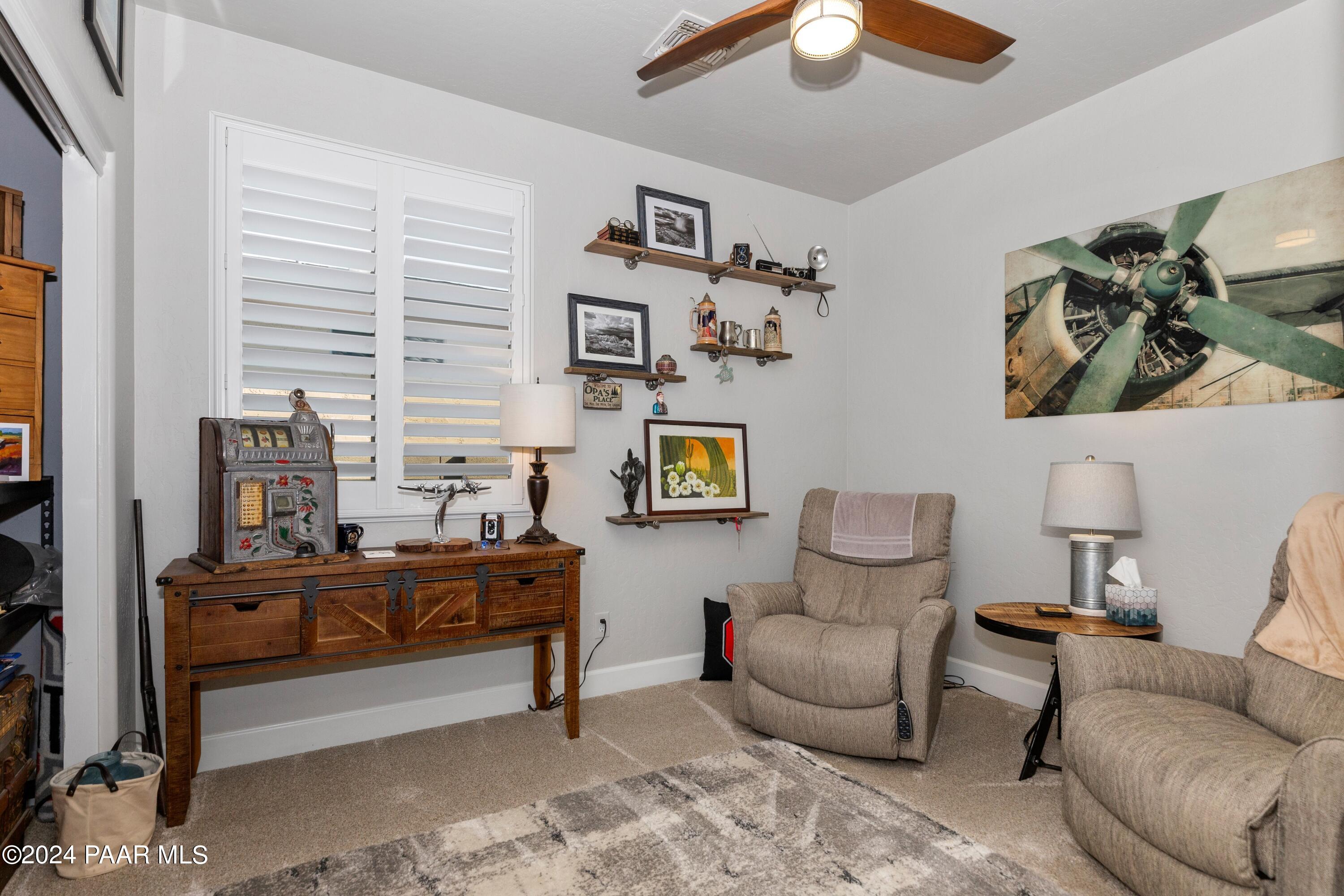 1219 Stack Rock Road Prescott Valley, AZ 86314 - Photo 24 of 41 a living room with furniture and a lamp