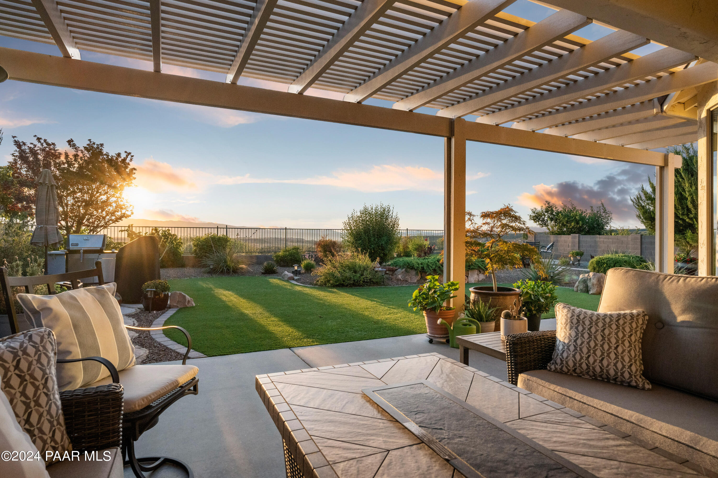 1219 Stack Rock Road Prescott Valley, AZ 86314 - Photo 30 of 41 a view of a patio with couches chairs dining table and chairs with wooden floor