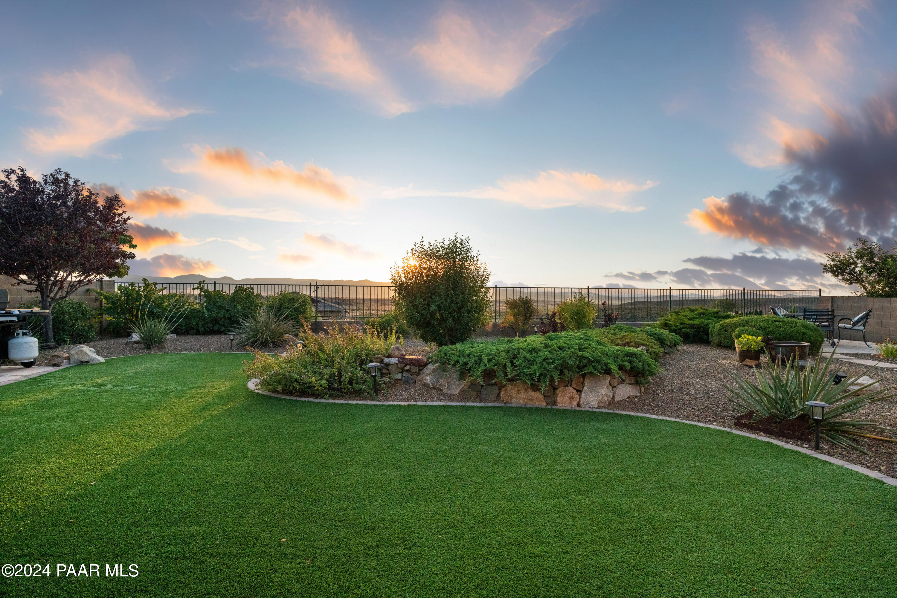 1219 Stack Rock Road Prescott Valley, AZ 86314 - Photo 39 of 41 a view of a garden with a building in the background