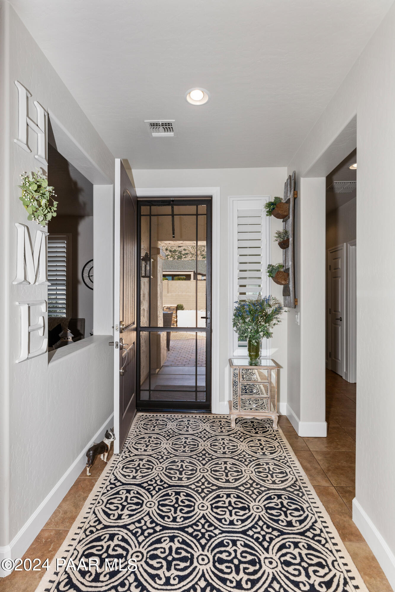 1219 Stack Rock Road Prescott Valley, AZ 86314 - Photo 7 of 41 a hallway with a dining table and chair