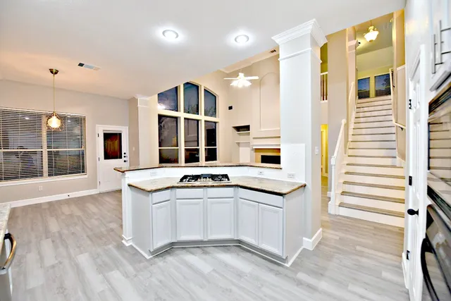 a kitchen with stainless steel appliances granite countertop a sink and a stove
