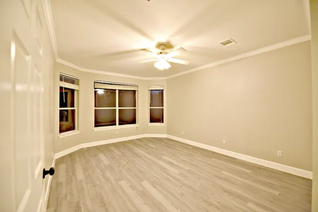 wooden floor in a room next to a window