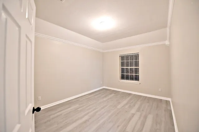 a view of a room with wooden floor and windows in a room