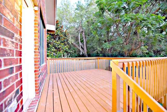 a view of balcony with wooden floor