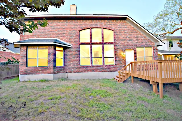 a front view of a house with a yard and outdoor seating