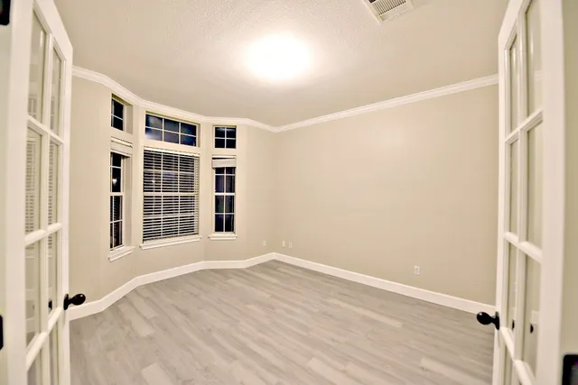 a view of wooden floor and windows in a room