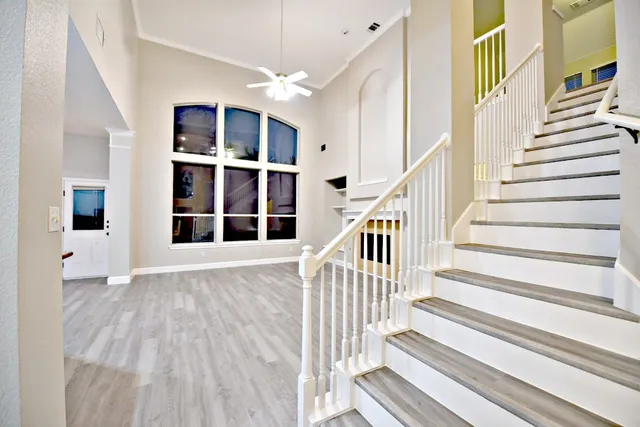 a view of staircase with wooden floor and a floor to ceiling window