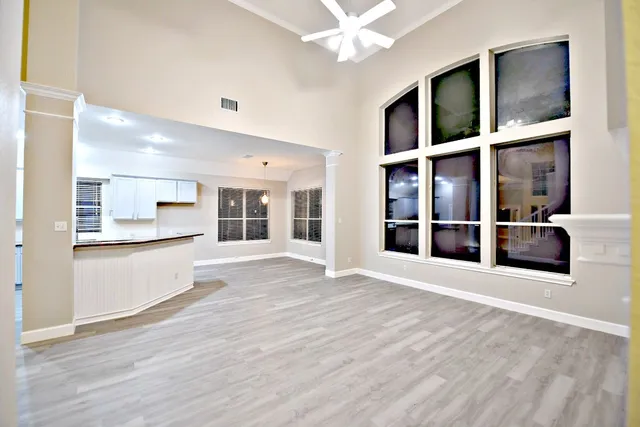 a view of an entryway with wooden floor and cabinet