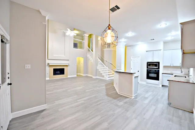 a view of kitchen with sink and refrigerator