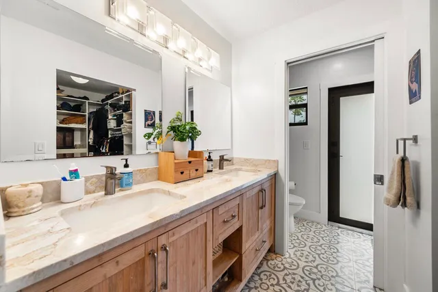 a bathroom with a double vanity sink and a mirror