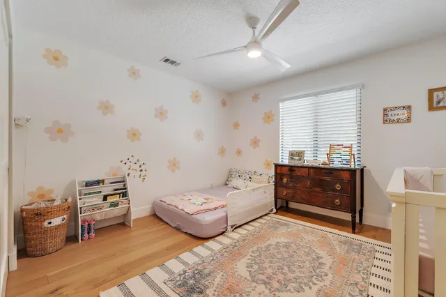 a bedroom with furniture and a wooden floor