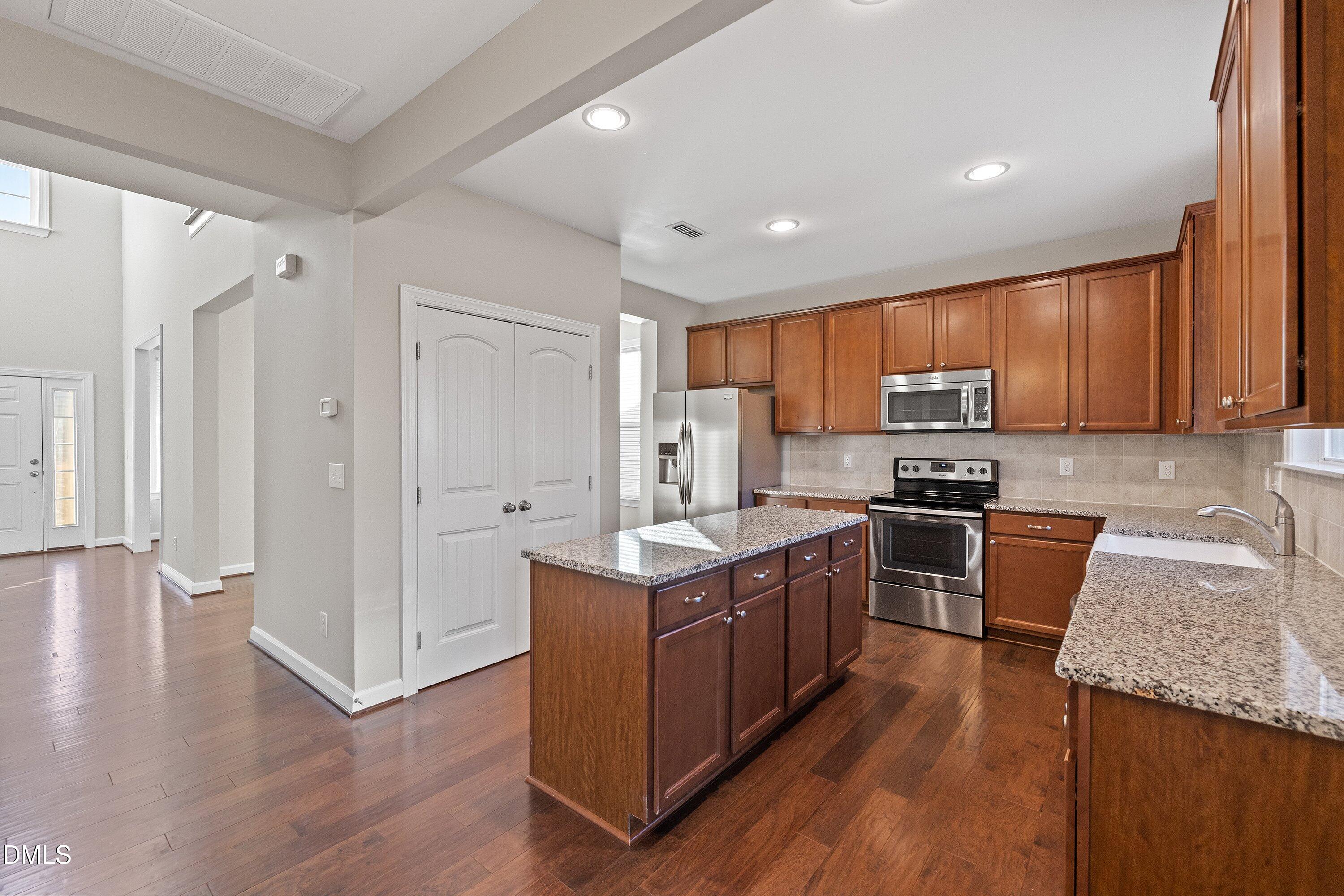 721 Maple Brook Road Fuquay-Varina, NC 27526 - Photo 12 of 59 Gorgeous Kitchen with granite countertops and tiled backsplash.
