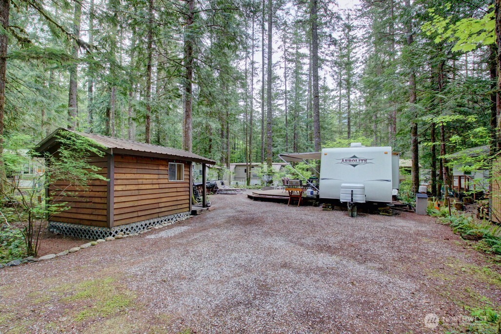 a view of a house with a backyard and trees