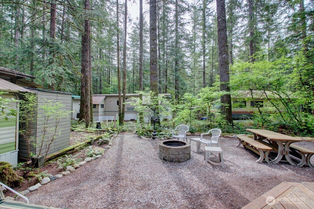 71 Wilderness Way Deming, WA 98244 - Photo 17 of 30 a view of a backyard with sitting area and garden