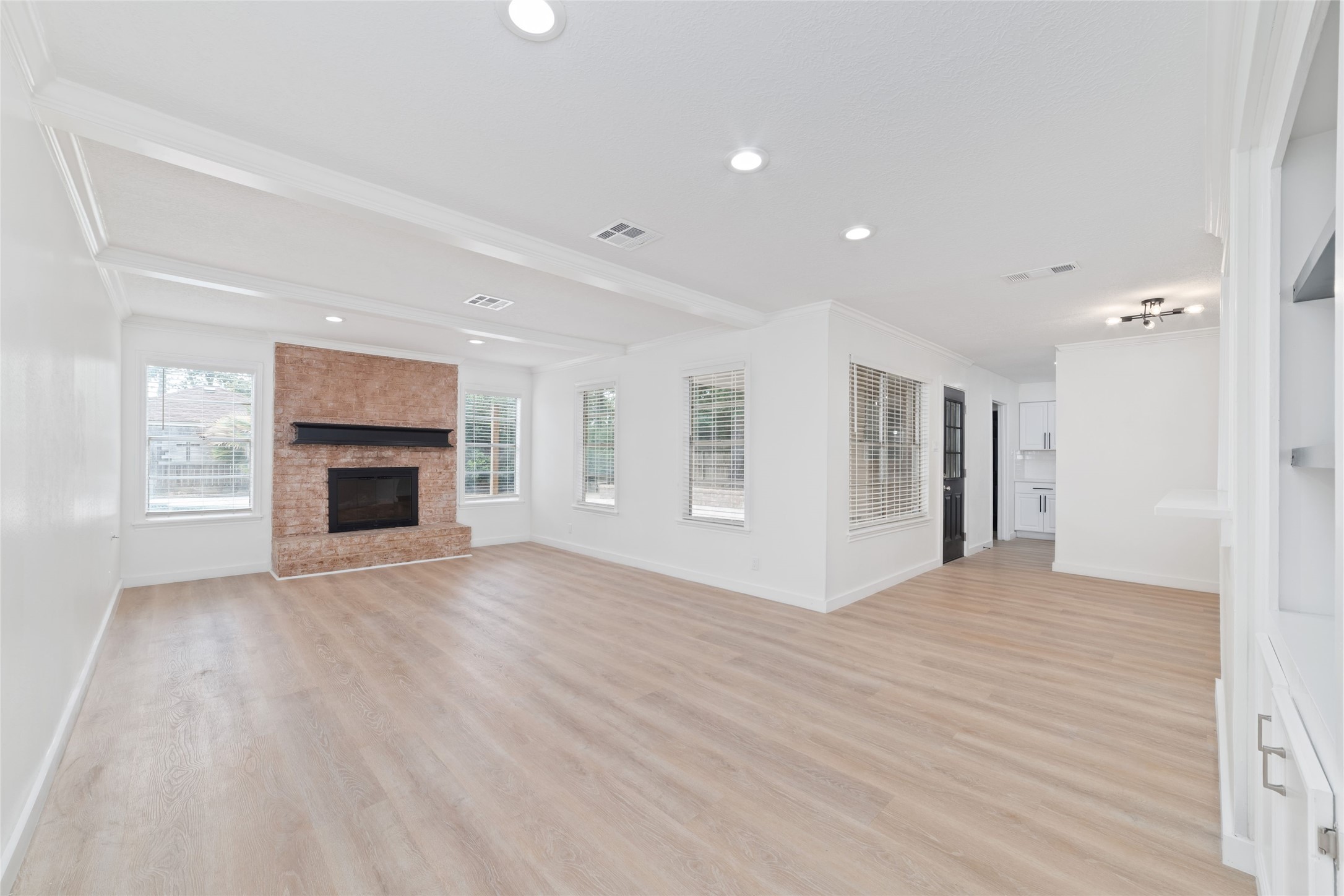 7910 Oak Moss Drive Spring, TX 77379 - Photo 6 of 38 Living room with a classic fireplace and a wall of windows to catch natural light