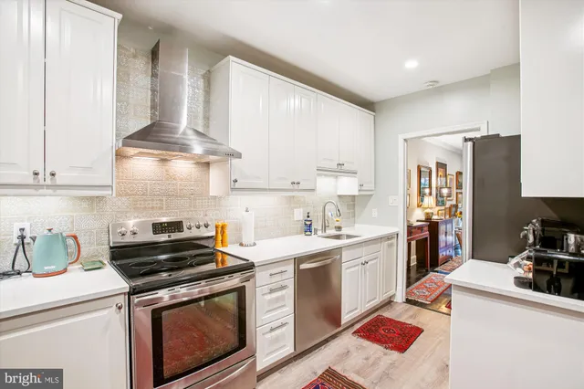 a kitchen with a stove oven and sink