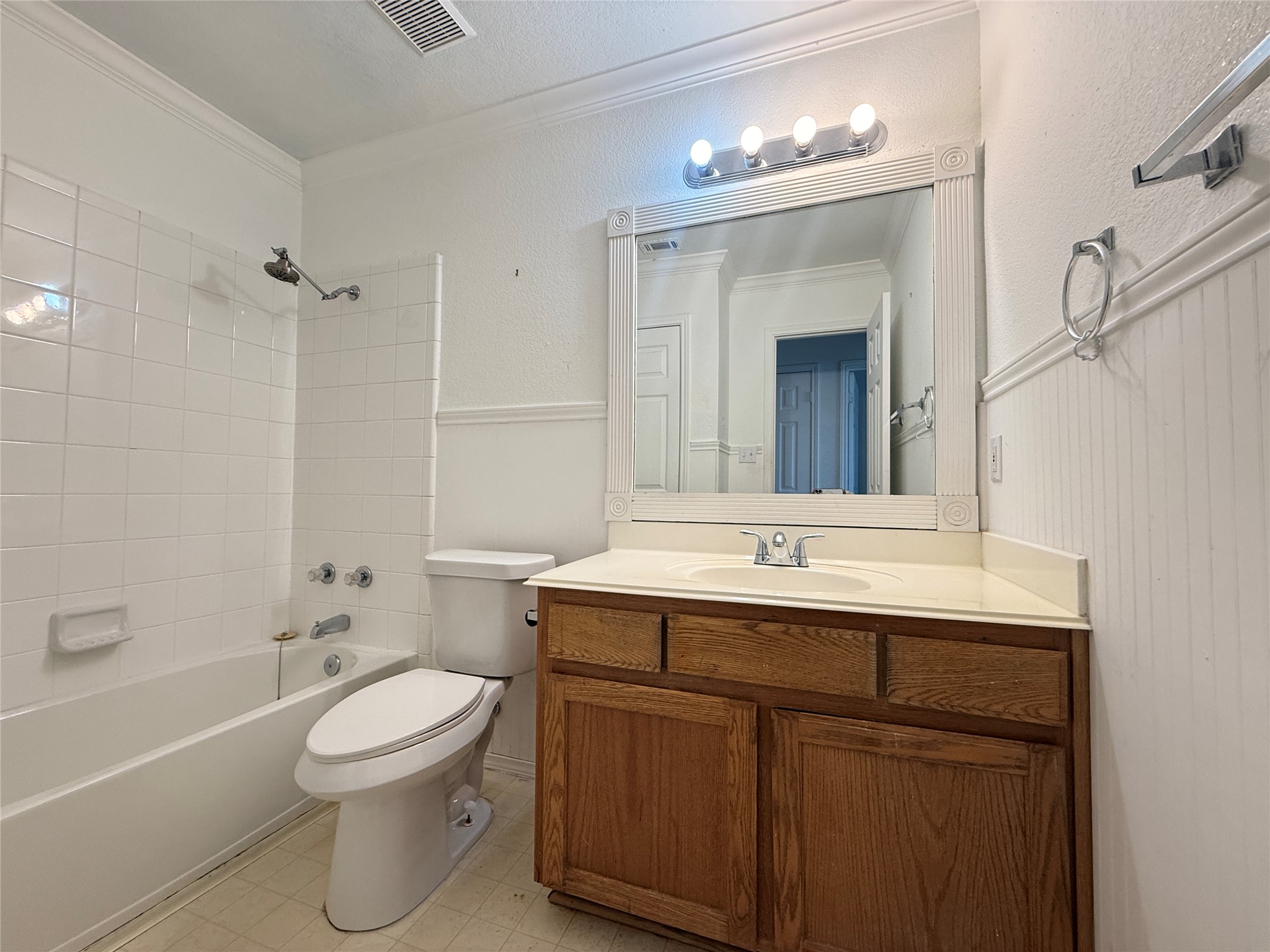 708 Spring Brook Lane Leander, TX 78641 - Photo 20 of 27 Full bathroom featuring shower combination, vanity, and crown molding