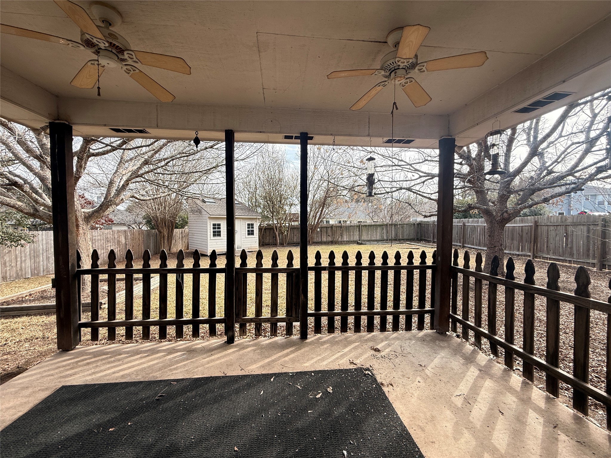 708 Spring Brook Lane Leander, TX 78641 - Photo 24 of 27 Wooden deck featuring ceiling fan, an outdoor structure, and a fenced backyard
