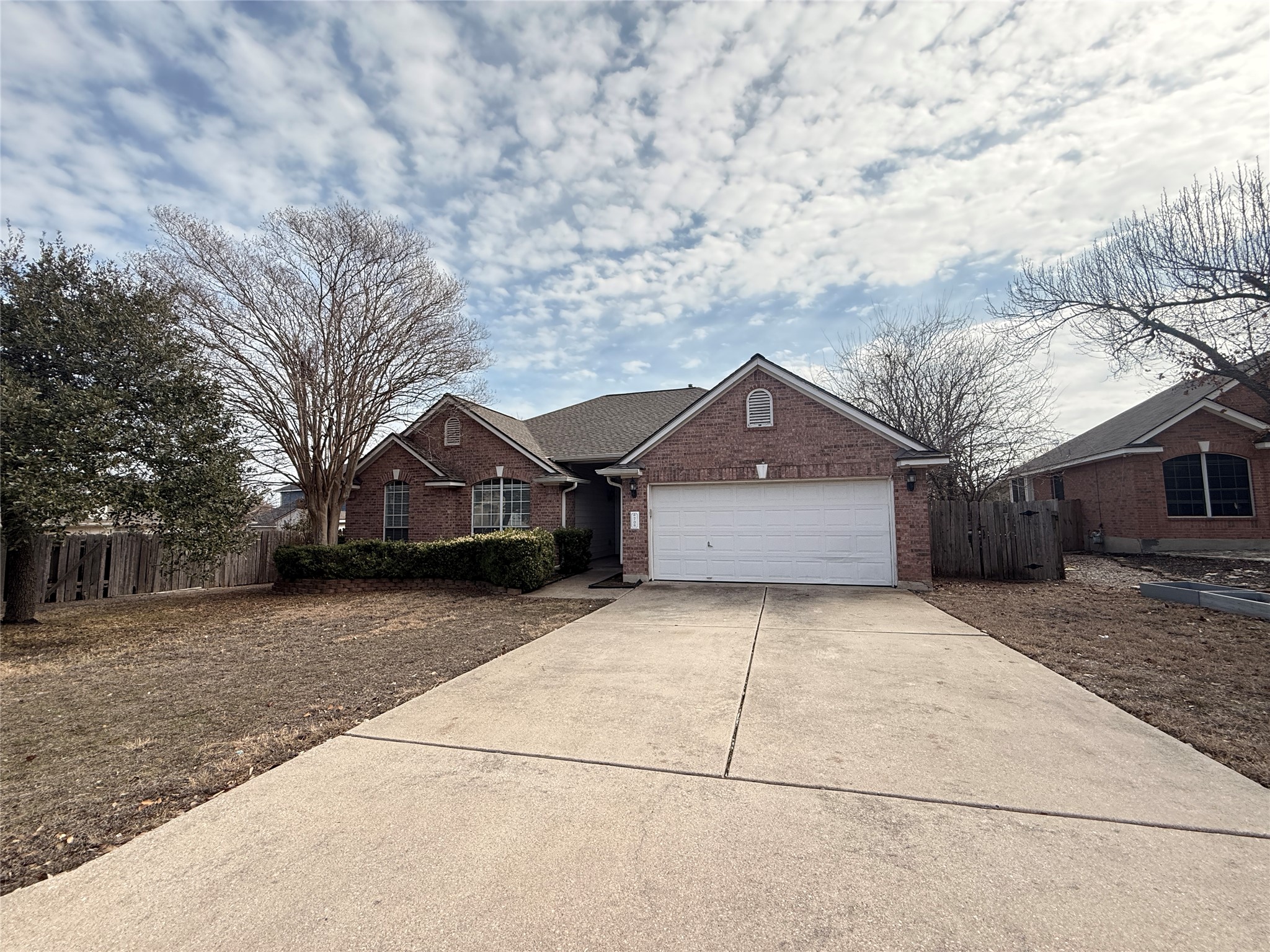 708 Spring Brook Lane Leander, TX 78641 - Photo 3 of 27 Traditional home with concrete driveway, brick siding, and a garage