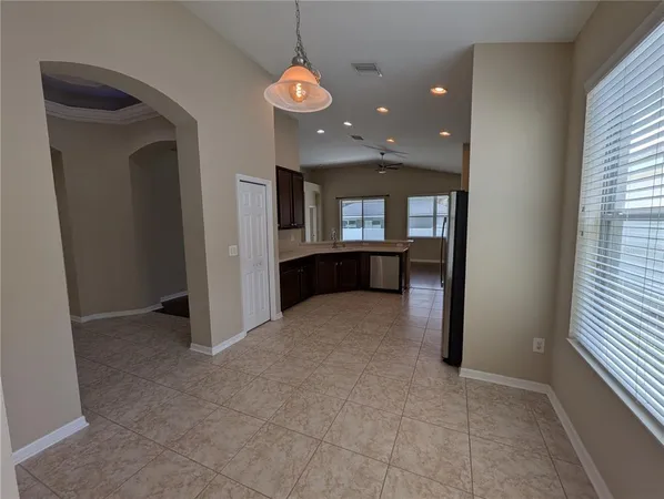 a large kitchen with a large counter top appliances and cabinets