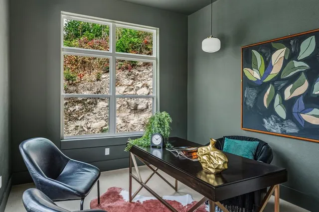 a living room with furniture and flowers