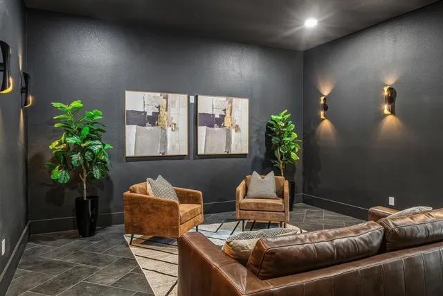a living room with furniture and a potted plant