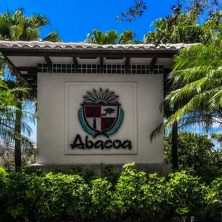 a row of palm trees in front of a building