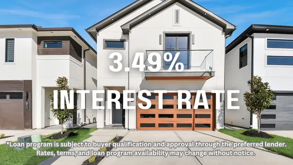a view of a white house with a large windows and plants
