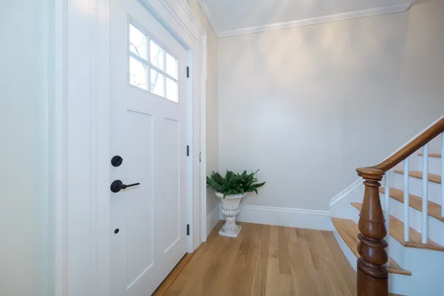 a view of staircase with white walls and railing