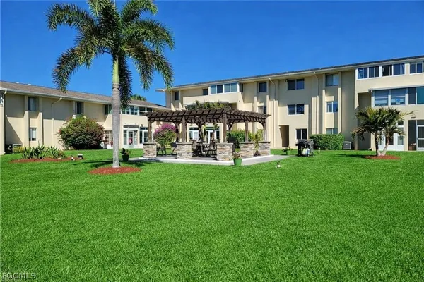 a front view of a house with a yard table and chairs