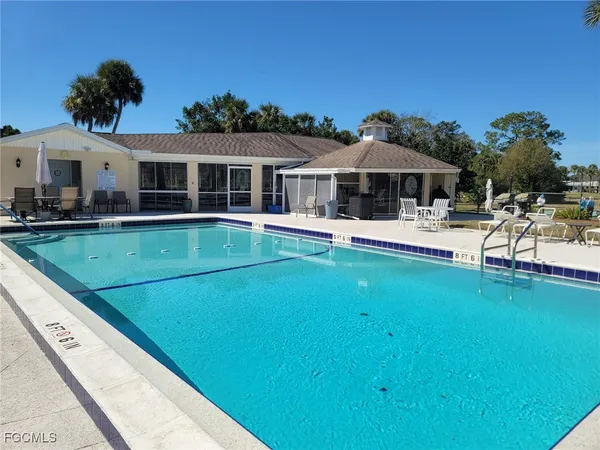 a view of a house with pool porch and chairs