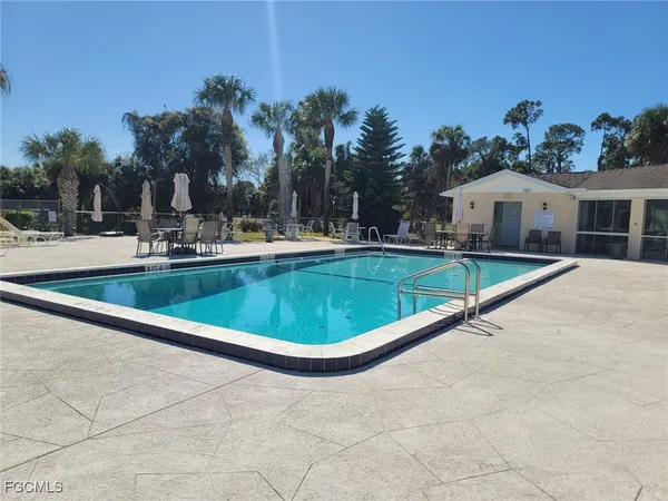 a view of a house with swimming pool and a yard