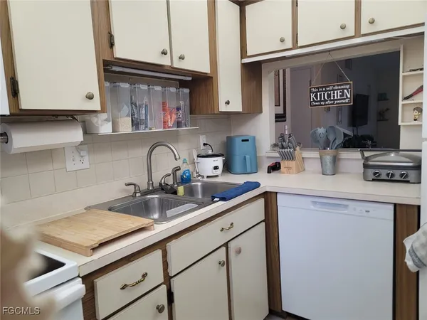 a kitchen with stainless steel appliances granite countertop a sink and cabinets