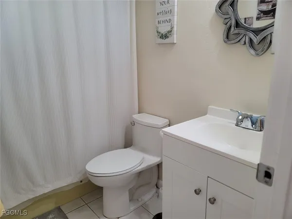a white toilet sitting next to a white sink