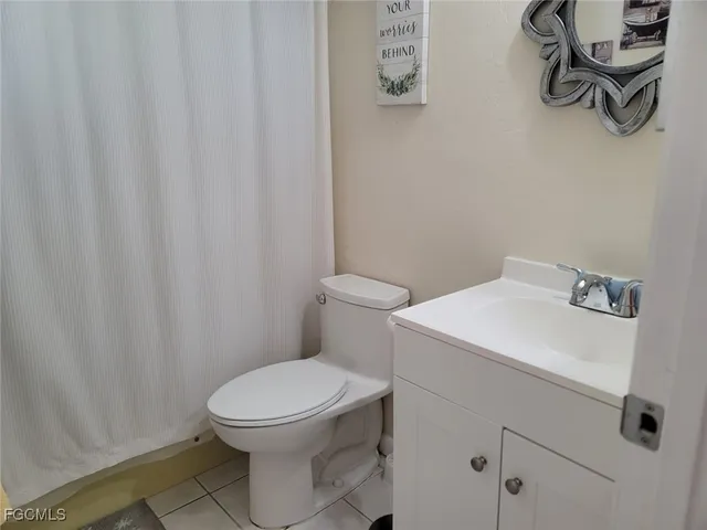 a white toilet sitting next to a white sink