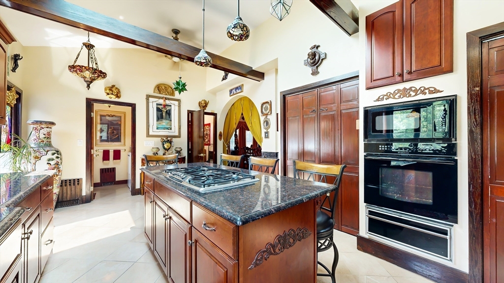 52 Thornton Park Winthrop, MA 02152 - Photo 14 of 40 a kitchen with stainless steel appliances granite countertop a stove and cabinets