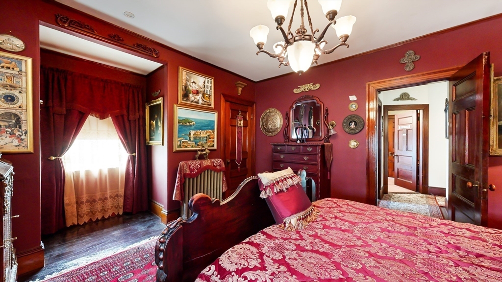 52 Thornton Park Winthrop, MA 02152 - Photo 20 of 40 a bedroom with a bed and a chandelier