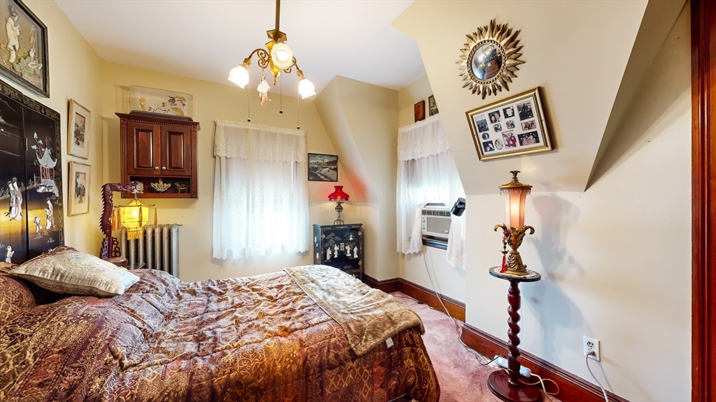 52 Thornton Park Winthrop, MA 02152 - Photo 22 of 40 a bedroom with a bed and a chandelier