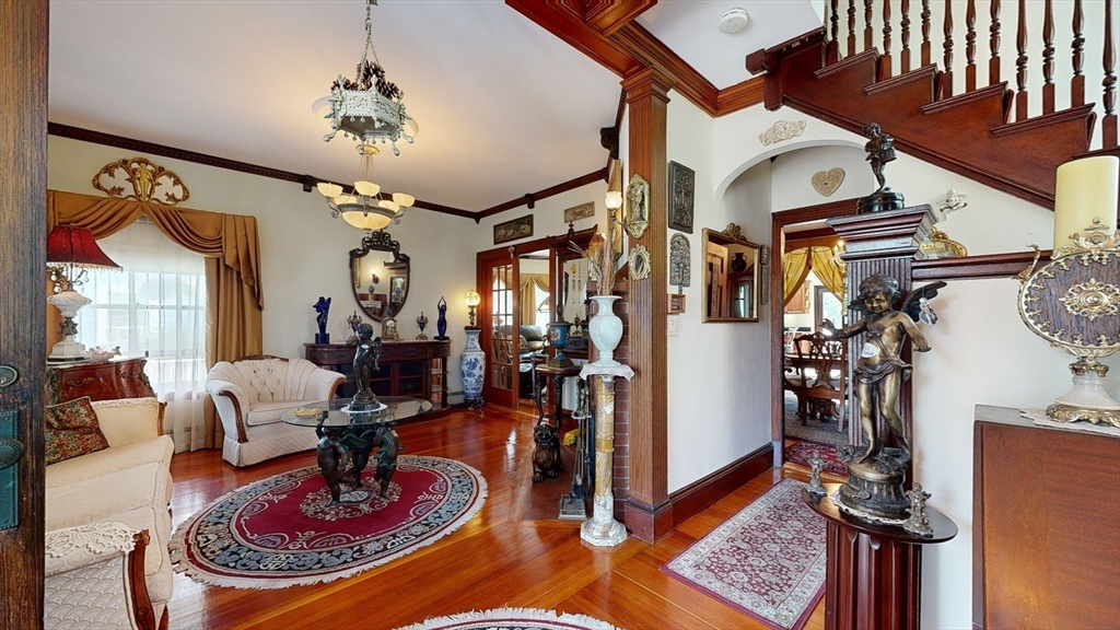 52 Thornton Park Winthrop, MA 02152 - Photo 6 of 40 a living room with furniture and a chandelier