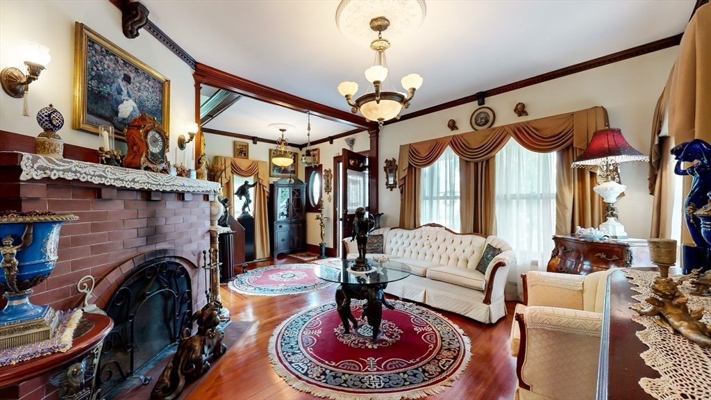 52 Thornton Park Winthrop, MA 02152 - Photo 8 of 40 a living room with furniture a fireplace and a chandelier