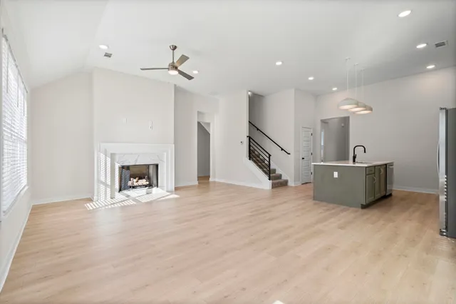 a view of a livingroom with a fireplace and staircase