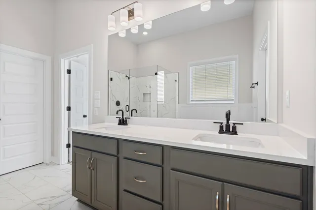 a bathroom with a sink double vanity and a mirror