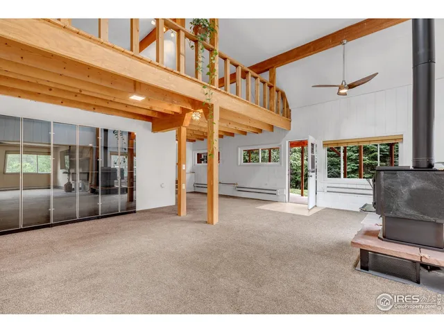 a living room with furniture a ceiling fan and a window