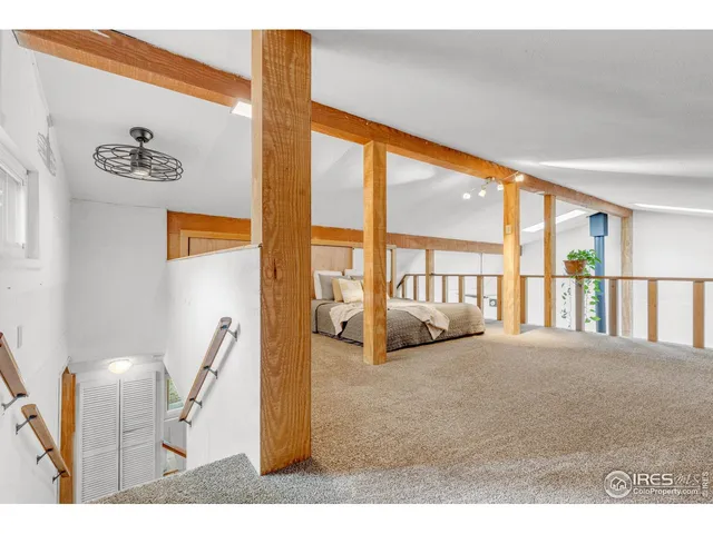 a bedroom with furniture and large window
